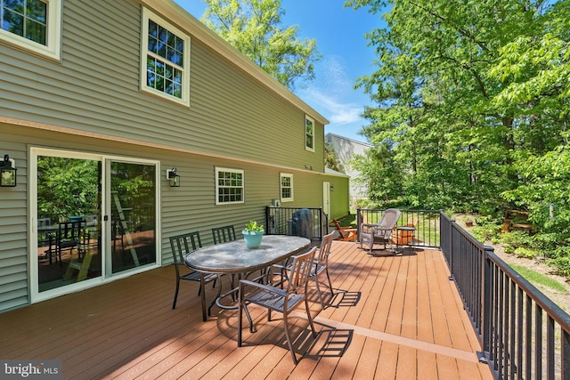 wooden deck with outdoor dining space