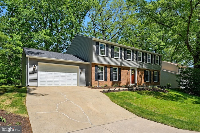colonial home featuring an attached garage, concrete driveway, brick siding, and a front yard
