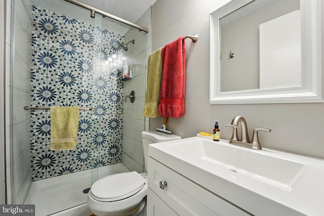 full bath featuring vanity, a shower stall, and toilet