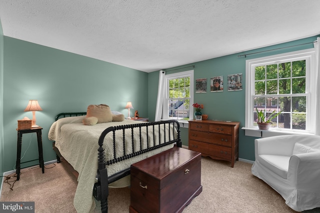 carpeted bedroom with baseboards and a textured ceiling