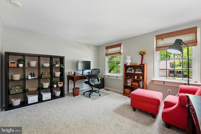 carpeted home office featuring baseboards and visible vents
