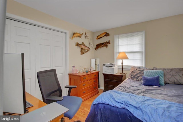bedroom with a closet and light wood-style flooring