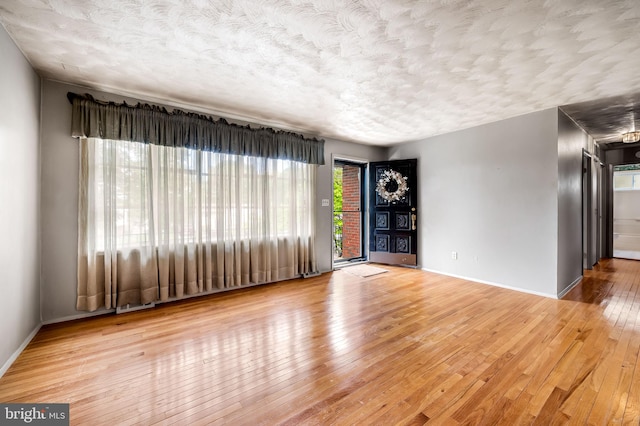 5303 Dew Garth, Baltimore, MD 21206 - spare room with a textured ceiling, baseboards, and wood-type flooring