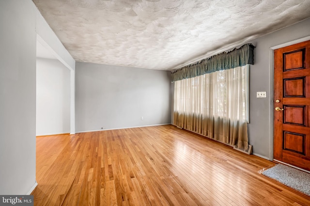 5303 Dew Garth, Baltimore, MD 21206 - foyer entrance featuring baseboards, a textured ceiling, and hardwood / wood-style flooring