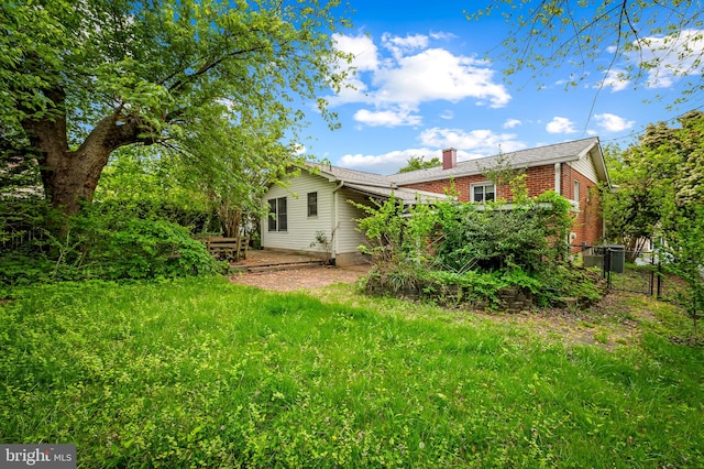 5303 Dew Garth, Baltimore, MD 21206 - rear view of house with a chimney, brick siding, and fence