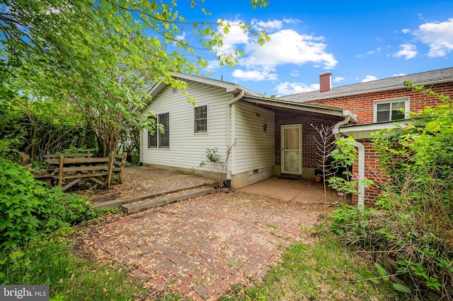 5303 Dew Garth, Baltimore, MD 21206 - rear view of house featuring brick siding, a patio, and a chimney
