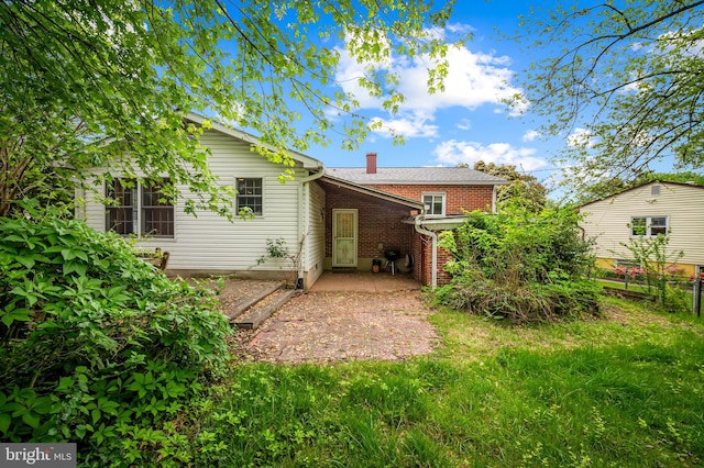 5303 Dew Garth, Baltimore, MD 21206 - back of house with fence, a patio area, a chimney, and brick siding
