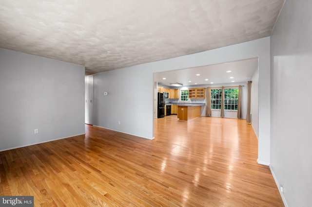 5303 Dew Garth, Baltimore, MD 21206 - unfurnished living room featuring baseboards, light wood-style floors, and recessed lighting