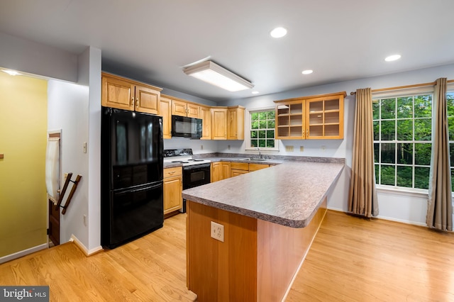 5303 Dew Garth, Baltimore, MD 21206 - kitchen with a peninsula, light wood-type flooring, black appliances, and a sink