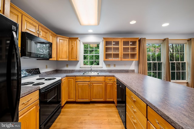 5303 Dew Garth, Baltimore, MD 21206 - kitchen featuring black appliances, dark countertops, light wood-type flooring, and a sink