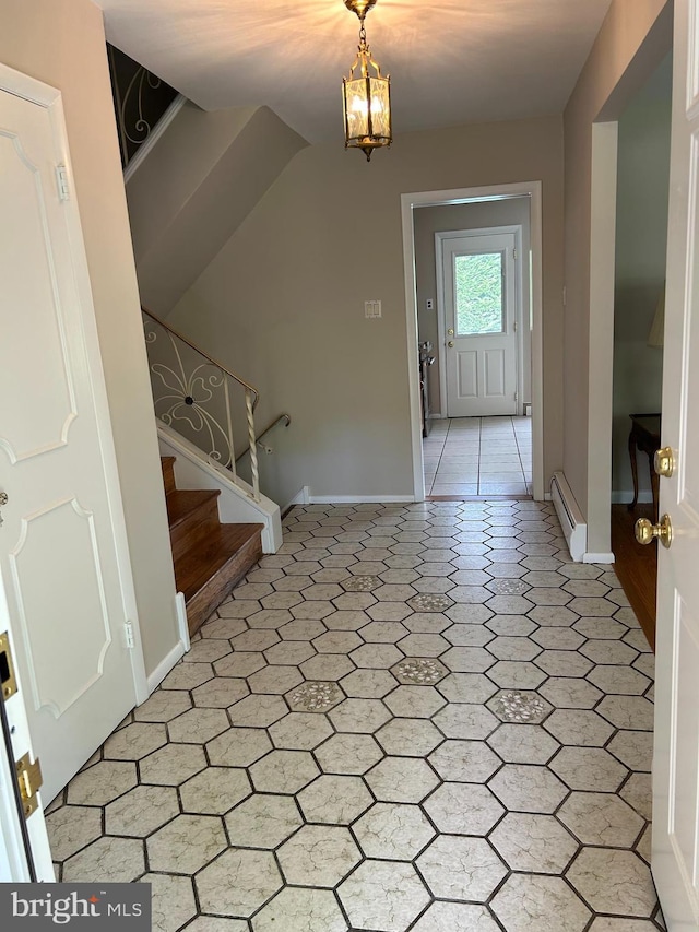 entrance foyer with baseboards, stairs, baseboard heating, and light floors