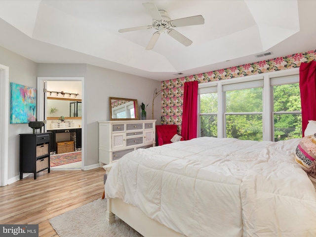 20636 Muddy Harbour Sq, Sterling, VA 20165 - bedroom featuring a tray ceiling, light wood-style flooring, baseboards, ceiling fan, and ensuite bathroom