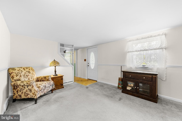 living area featuring carpet floors, a baseboard radiator, and baseboards