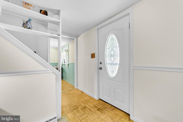 entryway with baseboards and a baseboard radiator