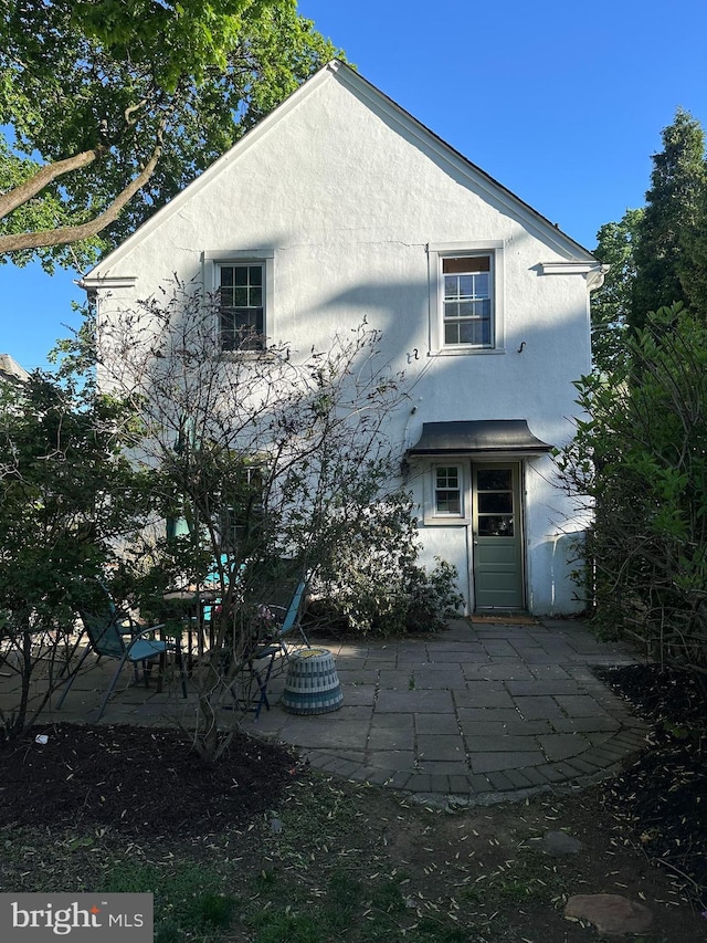 back of property featuring stucco siding and a patio area