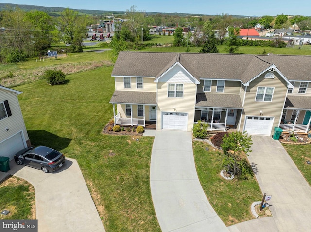 view of front of house featuring covered porch, a garage, and driveway