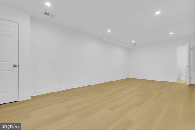 unfurnished room with baseboards, visible vents, light wood-type flooring, and recessed lighting