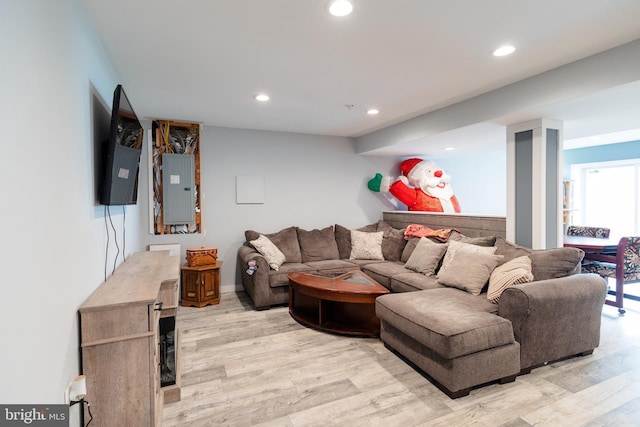 living area featuring recessed lighting, electric panel, and light wood-type flooring