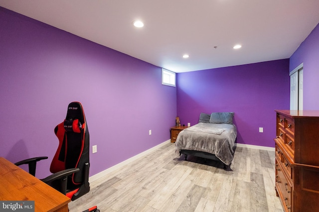 bedroom featuring wood finished floors, recessed lighting, and baseboards