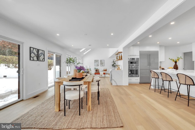 dining room with recessed lighting and light wood finished floors