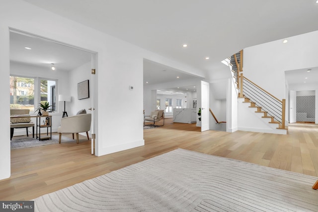 foyer entrance featuring recessed lighting, baseboards, stairs, and wood finished floors