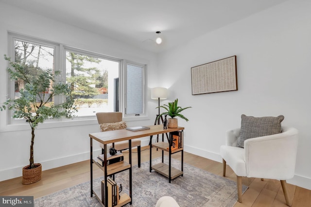 office area featuring baseboards and light wood finished floors