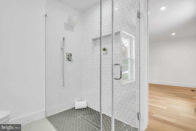 bathroom featuring recessed lighting, a shower stall, toilet, and wood finished floors