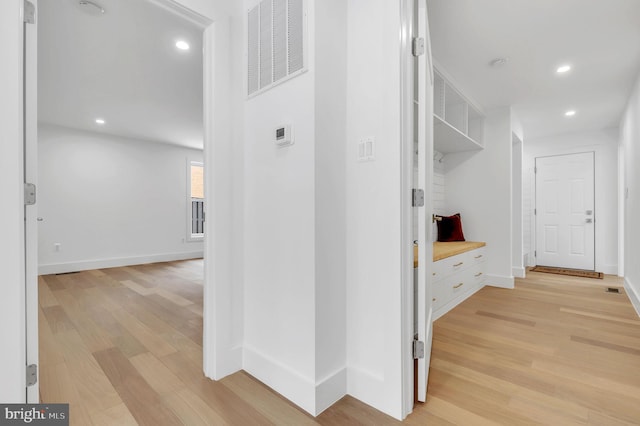 interior space featuring recessed lighting, baseboards, visible vents, and light wood finished floors