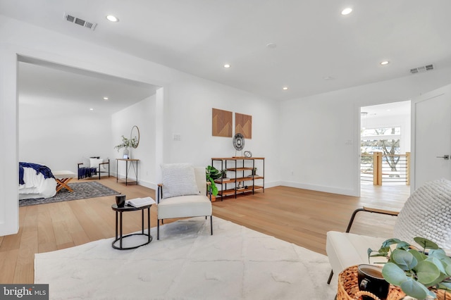 living area featuring recessed lighting, visible vents, and light wood-type flooring