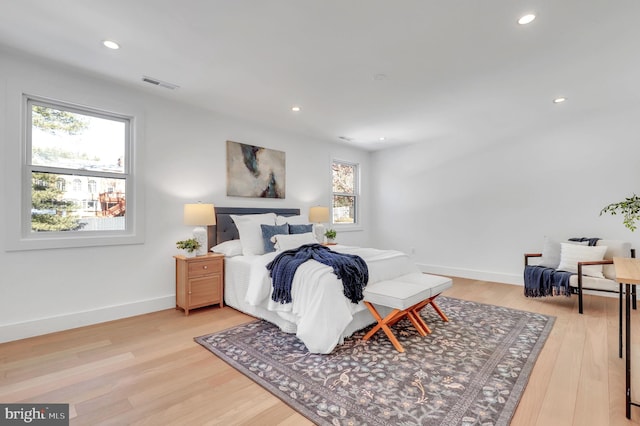 bedroom featuring light wood-style floors, multiple windows, recessed lighting, and visible vents