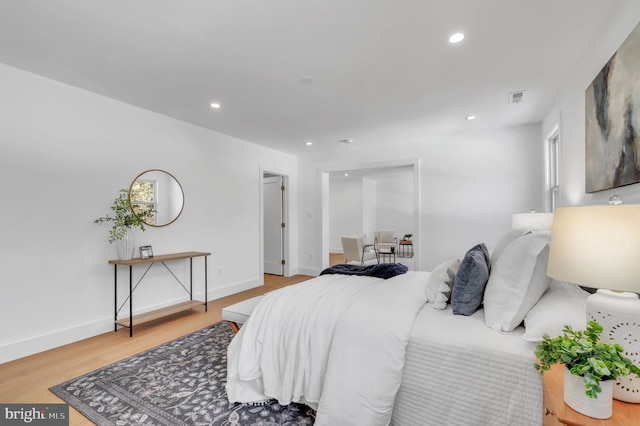 bedroom featuring visible vents, recessed lighting, baseboards, and wood finished floors