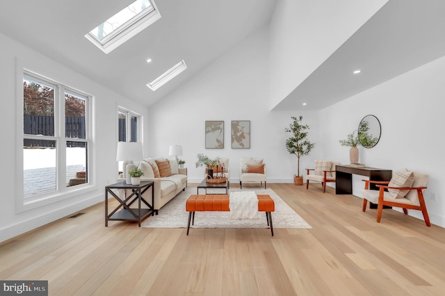 living room with high vaulted ceiling, recessed lighting, light wood-type flooring, a skylight, and visible vents