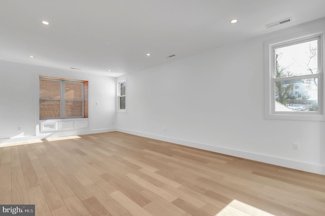 empty room with recessed lighting, light wood-style flooring, and visible vents