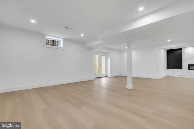 below grade area featuring recessed lighting, baseboards, visible vents, and light wood-style floors