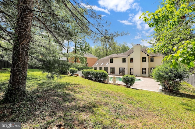 view of yard featuring a fenced in pool, a fenced backyard, and a patio area
