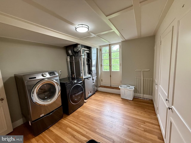 laundry room with independent washer and dryer and light wood finished floors