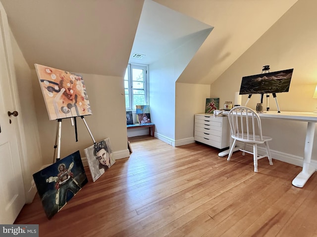 additional living space with lofted ceiling, hardwood / wood-style flooring, and baseboards