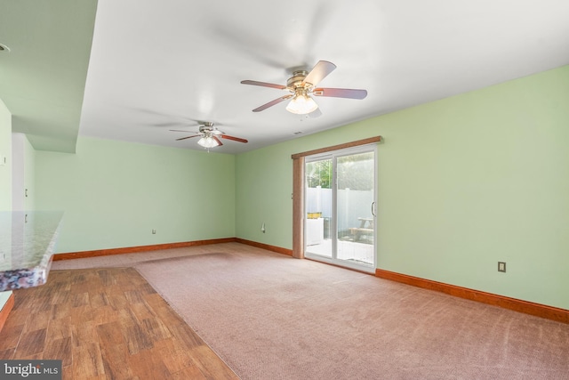 unfurnished living room with baseboards, a ceiling fan, and wood finished floors