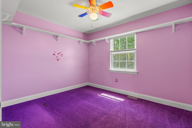 carpeted empty room featuring baseboards, a ceiling fan, and visible vents