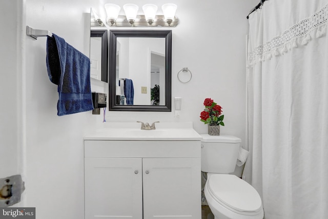 bathroom featuring toilet and vanity