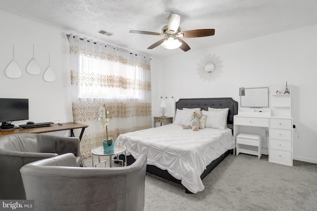 bedroom featuring carpet, a ceiling fan, and visible vents