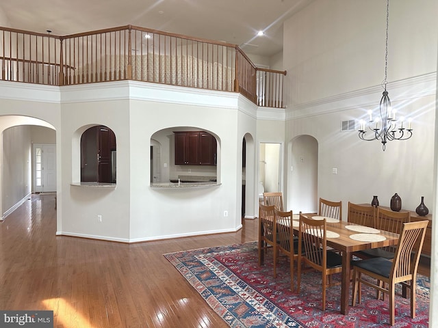 2435 Mill Race Rd, Frederick, MD 21701 - dining room with wood finished floors, a high ceiling, visible vents, baseboards, and arched walkways