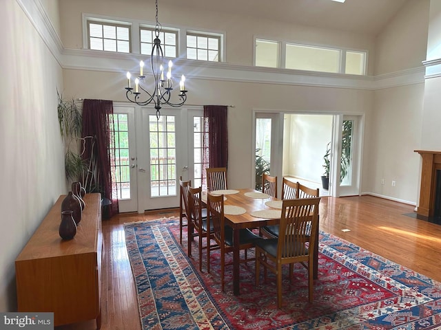 2435 Mill Race Rd, Frederick, MD 21701 - dining space featuring a high ceiling, wood finished floors, a healthy amount of sunlight, and a notable chandelier