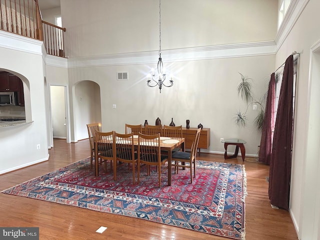 2435 Mill Race Rd, Frederick, MD 21701 - dining space with arched walkways, visible vents, a high ceiling, and wood finished floors