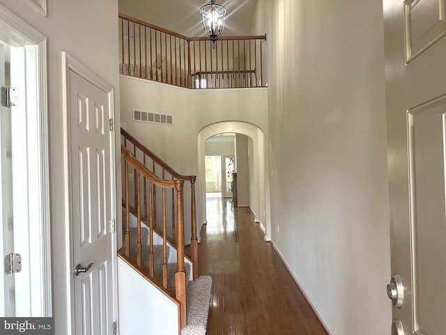 2435 Mill Race Rd, Frederick, MD 21701 - entrance foyer featuring wood finished floors, visible vents, stairway, arched walkways, and a high ceiling