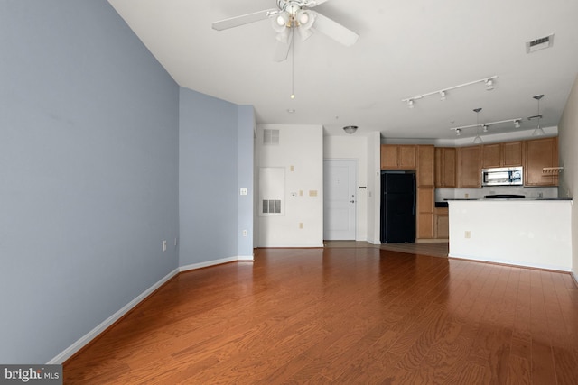 unfurnished living room with visible vents, ceiling fan, wood finished floors, and baseboards