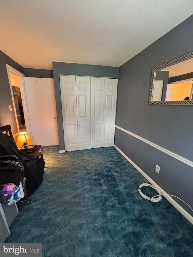 unfurnished bedroom featuring carpet floors, a closet, and baseboards