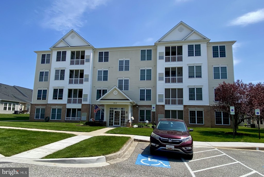 view of building exterior with uncovered parking