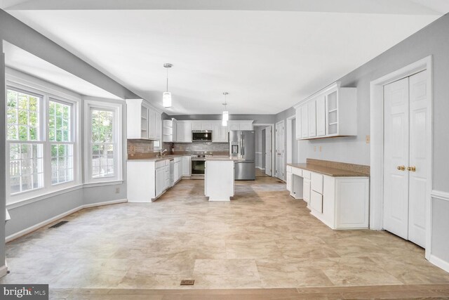 kitchen featuring white cabinets, open shelves, and stainless steel appliances