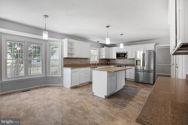 kitchen with visible vents, open shelves, white cabinets, tasteful backsplash, and stainless steel appliances